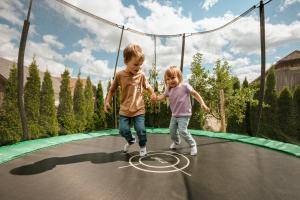 two children are playing on a trampoline at Feriendorf Edelweiss in Mariapfarr +23 photos