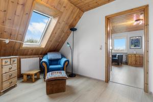 a room with a chair and a lamp in a room at Watt'n Mehr in Krummhörn