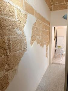 a wall in a room with a brick wall at Gallipoli - Suite Levante in Gallipoli +6 photos