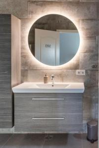 a bathroom with a sink and a mirror at Austurey - Lakefront Villa in Laugarvatn +49 photos