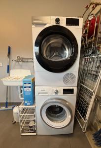 a washing machine and a dryer in a room at Austurey - Lakefront Villa in Laugarvatn