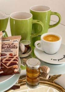 a table with two cups of coffee and cookies at Gallipoli - Suite Levante in Gallipoli