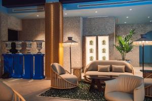 a lobby with a couch and a table and chairs at Nomada House by SH Hoteles in Denia