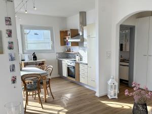 a kitchen and dining room with a table and chairs at Casa Rondinella by fewotessin in Orselina