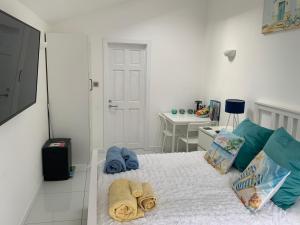 a bedroom with a bed with towels on it at Double Bedroom with Private Entrance in Weymouth