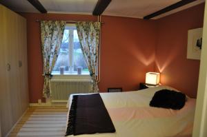 a bedroom with a bed and a window at The Gardener House - Grönsöö Palace Garden in Grönsöö