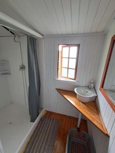 a small bathroom with a sink and a window at Hippo Waterfront Lodge in Nelspruit