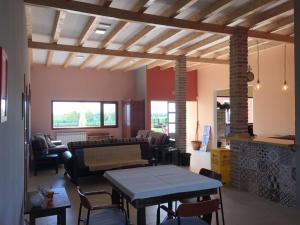 a living room with a couch and a table at Albergue La Perala in Bercianos del Real Camino