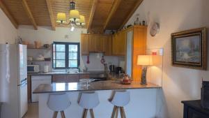 a kitchen with a counter with stools in it at Casa do Ti Chico in São Luis