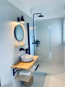a bathroom with a sink and a mirror at Como Lake Dreamscape Villa in Cernobbio +34 photos