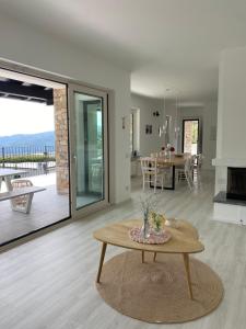 a living room with a table and a dining room at Como Lake Dreamscape Villa in Cernobbio