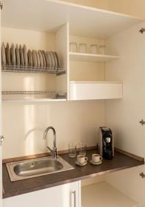 a kitchen counter with a sink and a toaster at Gallipoli - Suite Levante in Gallipoli