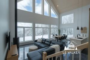 a living room with a couch and a table at Chalet Le Valkea - Spa & Mountain in Saint Come