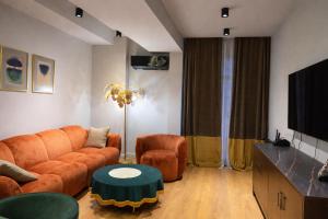 a living room with a couch and a table at Green House Mindeli in Tbilisi City