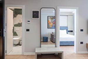 a mirror in a room with a bed at Boe Luxury Hotel in Sarandë +170 photos