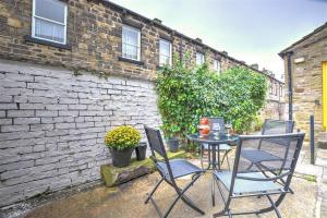 a table and chairs in front of a brick building at 2 Bed in Skipton oc-ds221 in Skipton