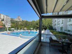 a view of a swimming pool from a window at Status-M Аpartments 173 in Bečići