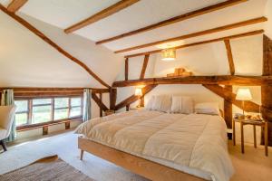 a bedroom with a large bed with wooden beams at 2 Bed in Dennington oc-b28093 in Dennington