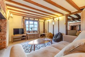 a living room with a couch and a tv at 2 Bed in Dennington oc-b28093 in Dennington