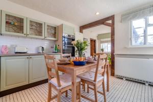 a kitchen with a wooden table and chairs at 2 Bed in Dennington oc-b28093 in Dennington