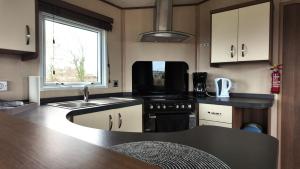 a kitchen with a sink and a stove top oven at Chalet 91 Retro in Westerland