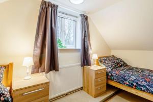 a bedroom with a bed and a window at 5 Bed in Chedgrave oc-twcg in Chedgrave