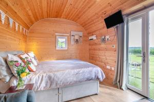 a bedroom with a bed in a wooden wall at 1 Bed in Cross oc-s29656 in Axbridge