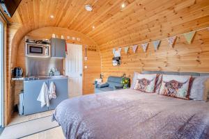 a bedroom with a bed in a log cabin at 1 Bed in Cross oc-s29656 in Axbridge