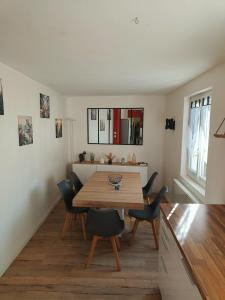 a dining room with a wooden table and chairs at Small townhouse in Clermont-Ferrand