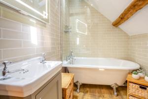 a bathroom with a white tub and a sink at 2 Bed in Penmaenpool oc-p32333 in Penmaenpool +18 photos
