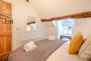 a bedroom with a bed with two towels on it at 2 Bed in Penmaenpool oc-p32333 in Penmaenpool