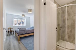 a bedroom with a bed and a glass shower at 5 Bed in Roxwell oc-t30824 in Roxwell +30 photos
