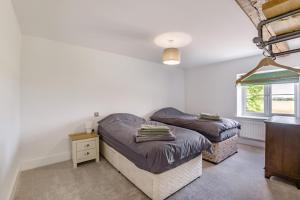 a bedroom with two twin beds and a window at 5 Bed in Roxwell oc-t30824 in Roxwell