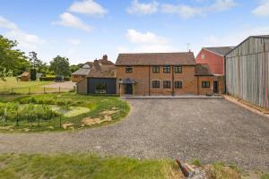 an aerial view of a house with a large driveway at 5 Bed in Roxwell oc-t30824 in Roxwell