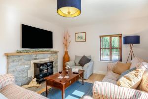 a living room with two couches and a fireplace at 4 Bed in Burrowbridge oc-o33020 in Athelney