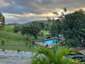 a swimming pool in the middle of a field at Villa Clarice in Bonao