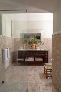 a bathroom with a large mirror and a sink at Riad Dar des Arts in Marrakesh +64 photos