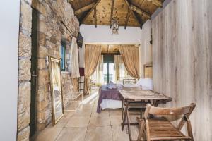a living room with a table and a bed at GAIA - Boutique Retreat in Marathopoli