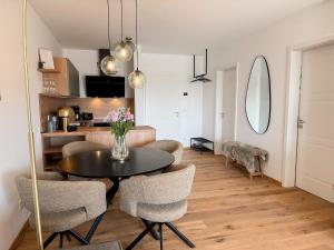 a dining room and living room with a table and chairs at Ferienwohnung Ufertraum am Dümmer See in Lembruch
