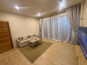 a living room with a couch and a table at Summer Sand in Haad Rin