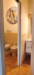 a bathroom with a sink and a toilet and a mirror at Dimora del Passaggio in Castiglion Fiorentino