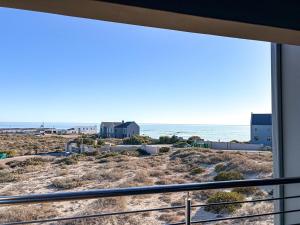 a view of the beach from the balcony of a house at Casa Costeira in Britannia Bay