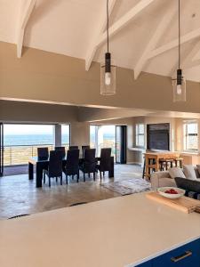 an open living room with a view of the ocean at Casa Costeira in Britannia Bay