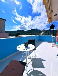 a patio with a white table and chairs on a balcony at Home4you in Skala Mistegnon