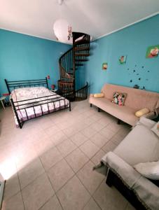 a living room with a bed and a staircase at Home4you in Skala Mistegnon