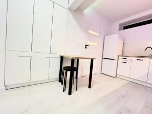 a kitchen with a table and a refrigerator at Lubicz Dolny, A1 Apartament 2 pokojowy in Lubicz