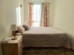 a bedroom with a bed and a window at Casa Madre Amada in Candelaria