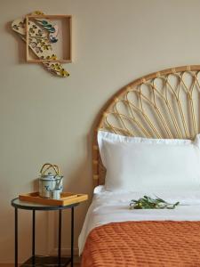 a bed with a wooden headboard and a side table at House Rong in Singapore
