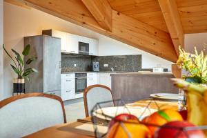 a kitchen and dining room with a table and chairs at Bader Suites - Apartments in Garmisch-Partenkirchen
