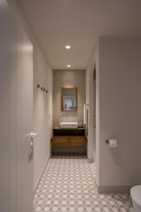 a bathroom with a sink and a toilet and a mirror at Apartamentos Boutique Casco Histórico in Las Lagunas +49 photos